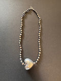 Large silver heart and peacock-hued pearl necklace