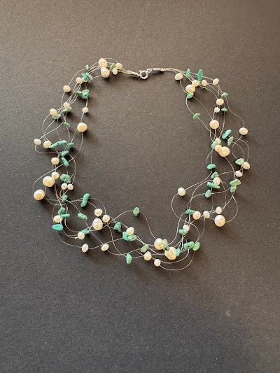 Multi-stranded 'floating' white pearl and green gemstone necklace