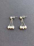 White oval pearl earrings on a pearl and sterling silver post