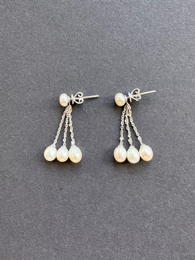 White oval pearl earrings on a pearl and sterling silver post