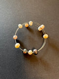 Flexible white, golden and peacock-hued pearl bracelet