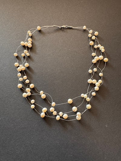 Multi-stranded 'floating' creamy-white-hued pearl necklace