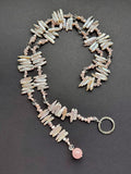 Pale pink-hued lariat stick pearl necklace with a polished rose quartz bead
