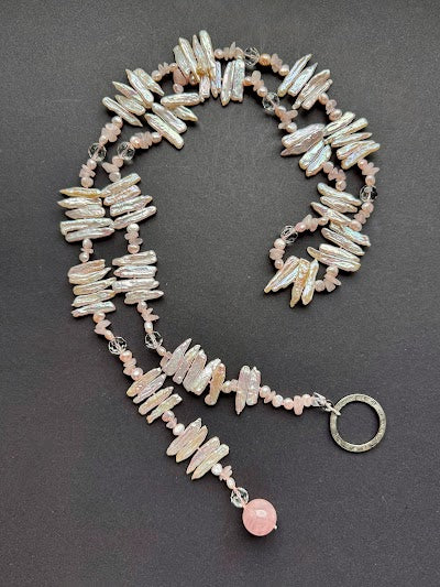 Pale pink-hued lariat stick pearl necklace with a polished rose quartz bead