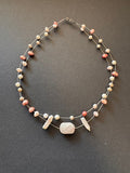 Freshwater pearl 'floating' necklace with a polished rose quartz stone