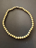 Pale olive green-hued pearl necklace