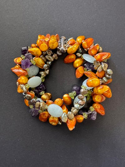 Multi-stranded orange pearl and blue gemstone bracelet
