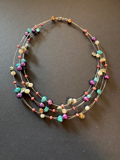 Multi-stranded teal pearl necklace
