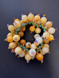 Polished light orange and mustard-hued jade stretch bracelet