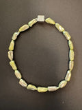 Pale olive green-hued elongated pearl necklace with box clasp
