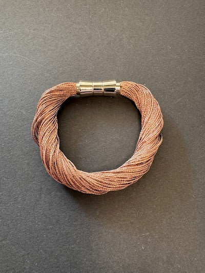 Rose gold-hued metallic thread bracelet