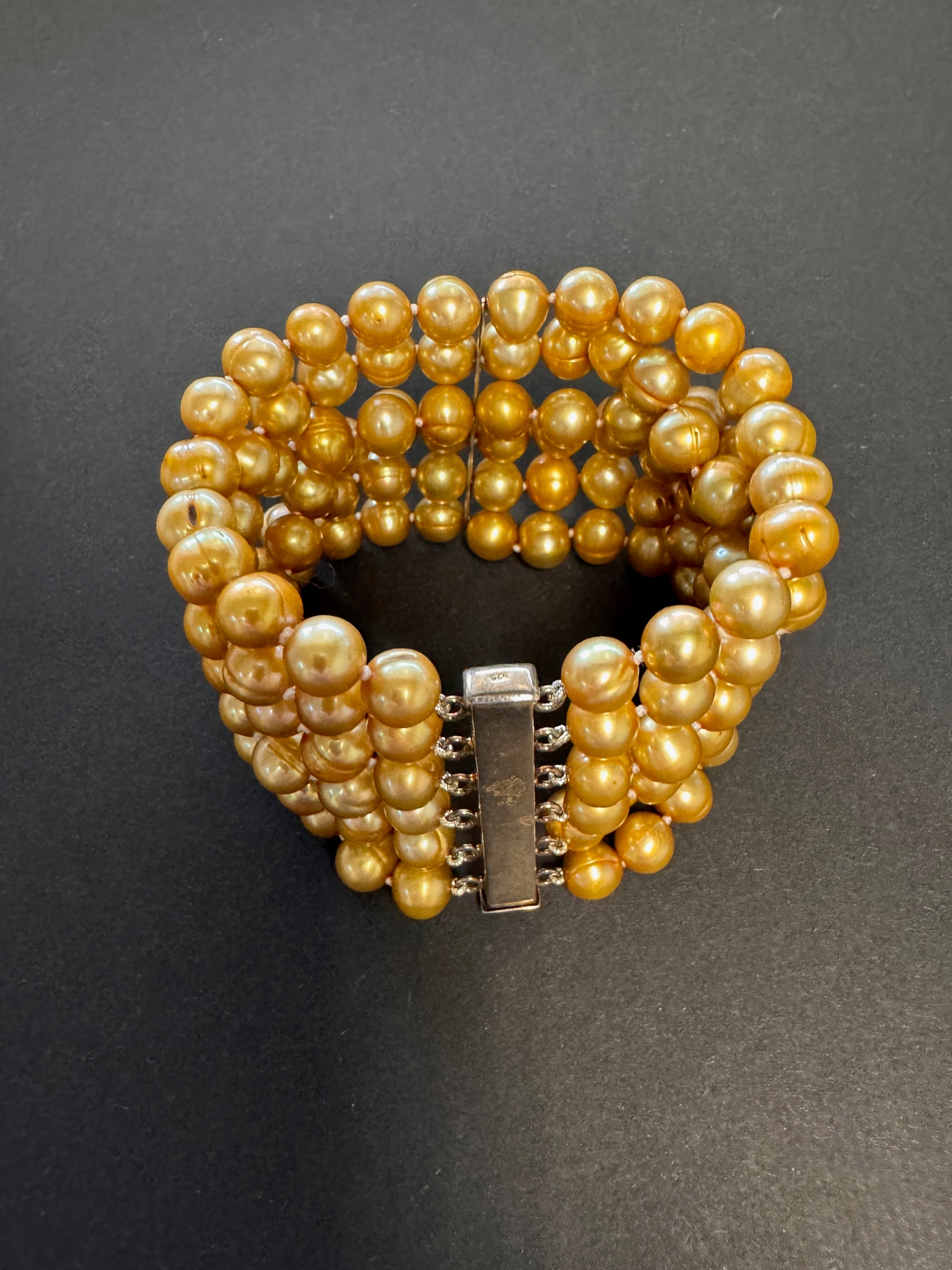 Multi-stranded golden-hued pearl bracelet