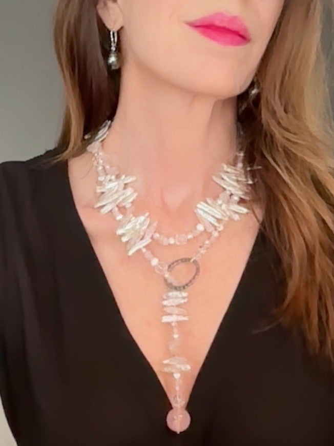 Pale pink-hued lariat stick pearl necklace with a polished rose quartz bead