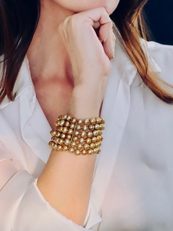Multi-stranded golden-hued pearl bracelet